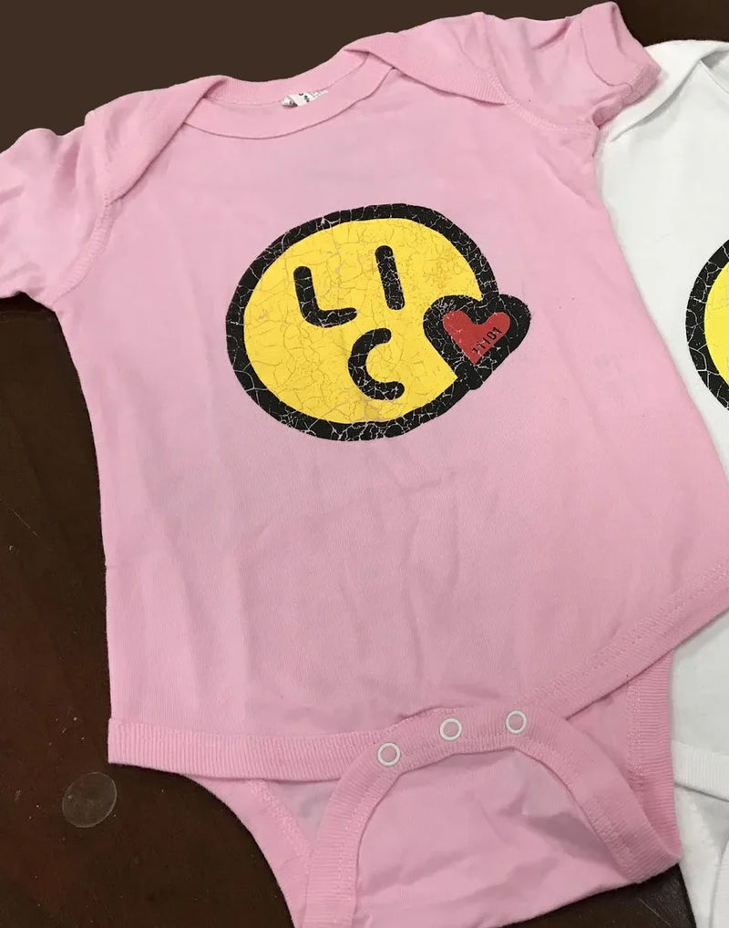 Pink baby onesie with LIC graphic