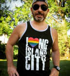 Man wearing a black tank top with 'I ❤️ NG ISLANDS CITY' text and rainbow heart symbol outdoors.