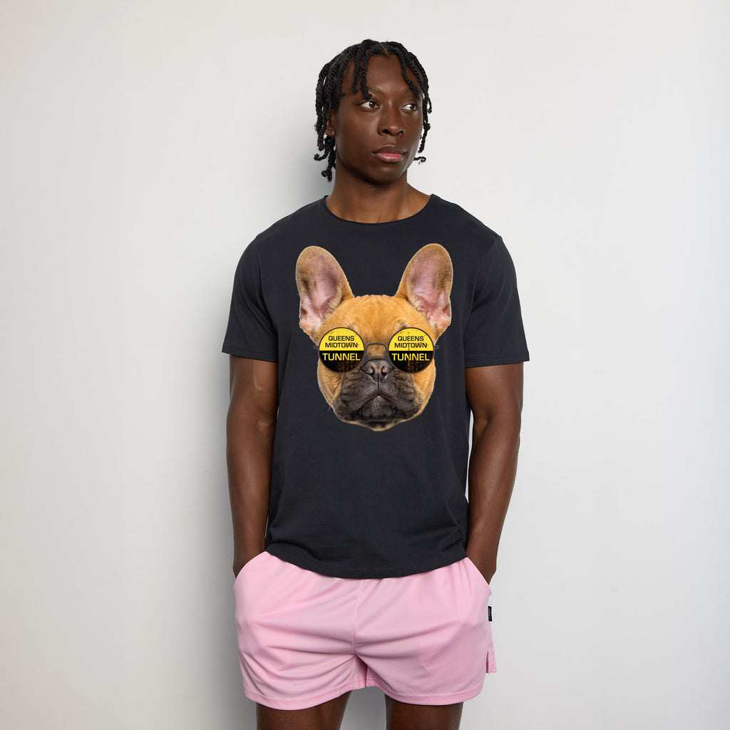 Male wearing a gray t-shirt with graphic of dog wearing glasses that say "Queens Midtown Tunnel".