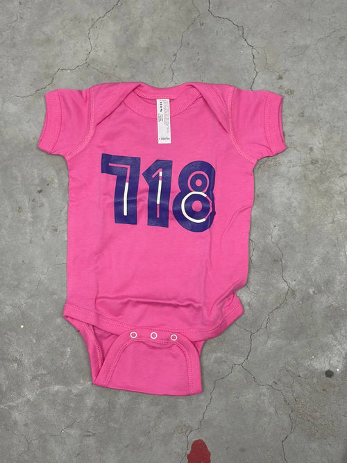 Pink baby onesie with purple '718' print
