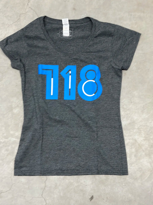 Women's gray v-neck t-shirt with blue '718' print on a light gray background