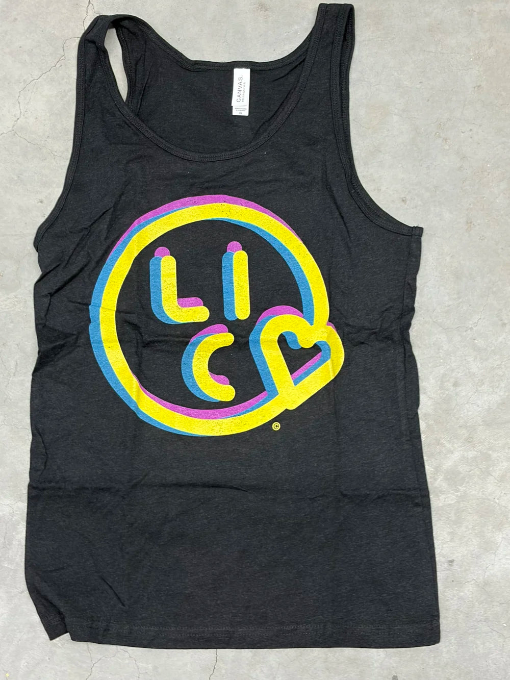 Black tank top with colorful Kiss LIC logo on a gray surface