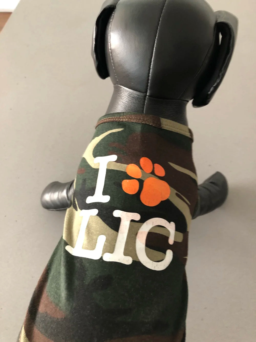 Camouflage dog shirt with 'I Paw LIC' text on a dog model.